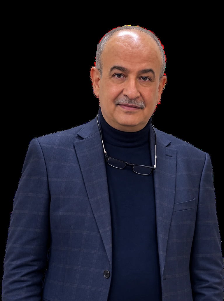 Middle-aged man with gray hair and mustache wearing a navy blazer and black turtleneck against a black background
